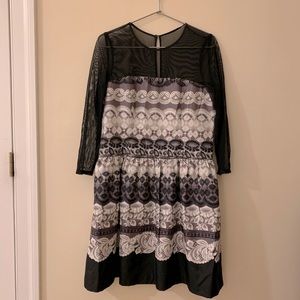 Formal dress with illusion neckline and sleeves.